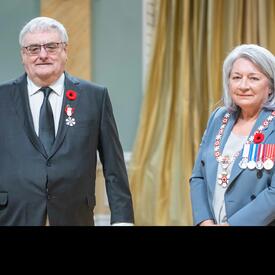 Maurice Brisson is standing next to the Governor General.