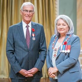 The Honourable James Cowan is standing next to the Governor General.