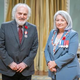 John Rea is standing next to the Governor General.