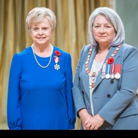 The Honourable Karen Merle Weiler is standing next to the Governor General.