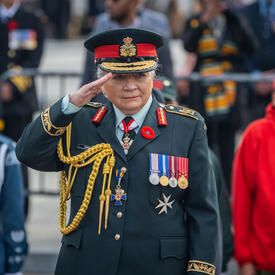 Governor General Mary Simon is saluting. She is wearing the Canadian Army uniform. 