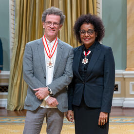 Yann Martel is standing next to The Right Honourable Michaëlle Jean.