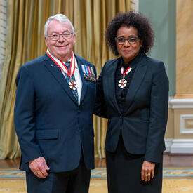 Robert Daniel Steadward is standing next to The Right Honourable Michaëlle Jean.