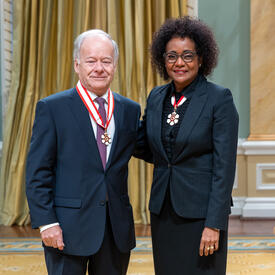 Raymond Bachand is standing next to The Right Honourable Michaëlle Jean.