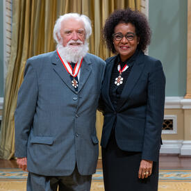 Ian Stewart Hodkinson is standing next to The Right Honourable Michaëlle Jean.