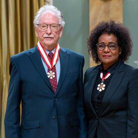 James V. Zidek is standing next to The Right Honourable Michaëlle Jean.