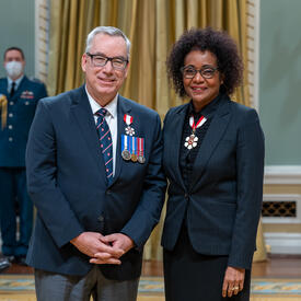 Yves Beauchamp is standing next to The Right Honourable Michaëlle Jean.