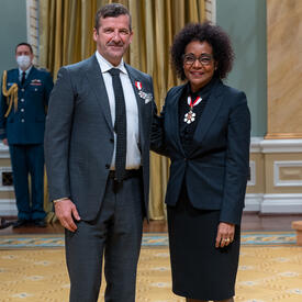 Darren Throop is standing next to The Right Honourable Michaëlle Jean.