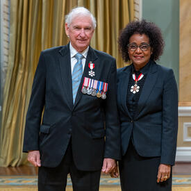 Gordon W. Walker is standing next to The Right Honourable Michaëlle Jean.