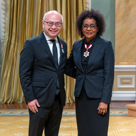 Roger Wong is standing next to The Right Honourable Michaëlle Jean.