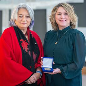 Denise LeBlanc is standing next to the Governor General.