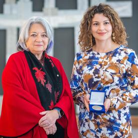 Luisa Fracassi is standing next to the Governor General.
