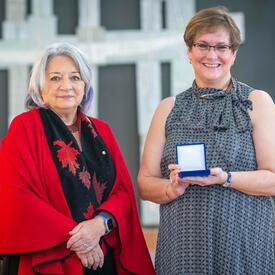 Barbara A. Giroux is standing next to the Governor General.