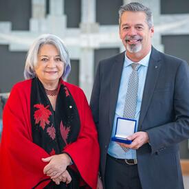 The Governor General is standing next to a recipient of the Governor General’s History Awards for Excellence in Community Programming.