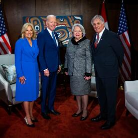 In order from left to right, First Lady Jill Biden, President Joe Biden, Governor General Simon, and Mr. Whit Fraser. They are posing for a group photo. 