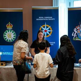 View of Royal Canadian Geographic Society table at Rideau Hall coronation event in Ottawa.