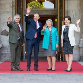 Governor General Marie Simon stands with Mr. Whit Fraser, Icelandic President Guðni Th. Jóhannesson and Ms. Eliza Reid in front of Rideau Hall.