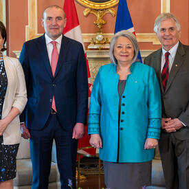 Governor General Marie Simon stands with Mr. Whit Fraser, Icelandic President Guðni Th. Jóhannesson and Ms. Eliza Reid inside Rideau Hall.