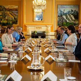Governor General Marie Simon and Icelandic President Guðni Th. Jóhannesson sit at a table during the roundtable discussion