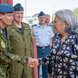 Governor General Marie Simon shakes hands with a member of the Canadian Armed Forces