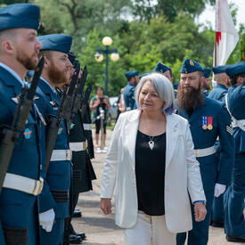 Governor General Marie Simon inspects a military honour guard