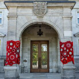Crochet art by Métis artist Tracey-Mae Chambers hangs on the porte-cochère of Rideau Hall