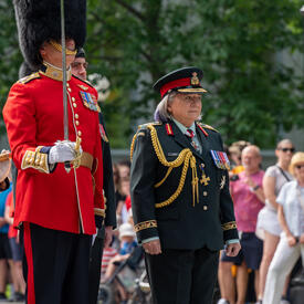 Governor General Mary Simon walks with the Commander of the Ceremonial Guard. She is wearing a Canadian Armed Forces army uniform.
