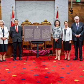 Governor General Marie Simon stands for a group photo accompanied by event organizers