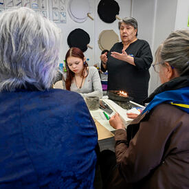 Governor General Mary Simon having a discussion with a group of individuals at the Piruqatigiit Resource Centre.
