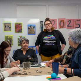 Governor General Mary Simon having a discussion with a group of individuals at the Piruqatigiit Resource Centre.