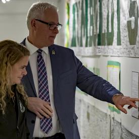 The exhibit features messages, banners, jerseys and hockey sticks, among many other paraphernalia. She read attentively the messages written in honour of those who perished.