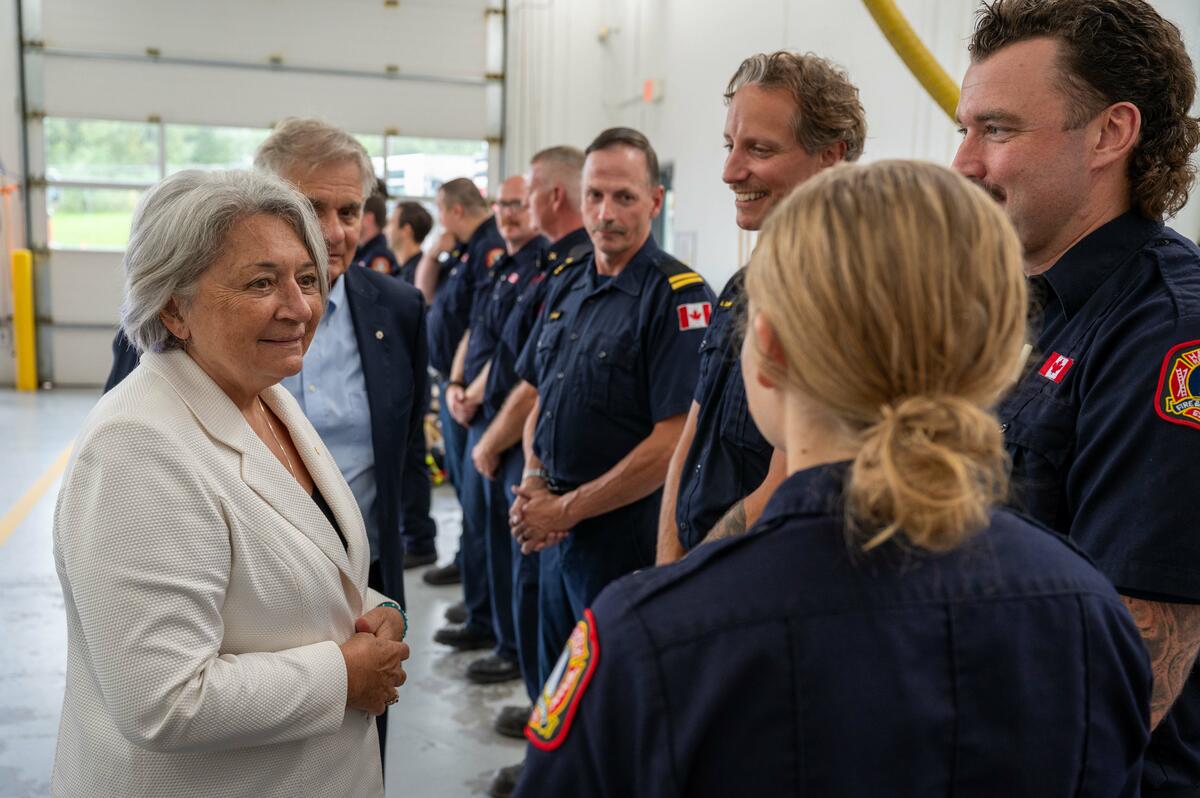 Governor General Mary Simon talks with with local firefighters, first responders and volunteers