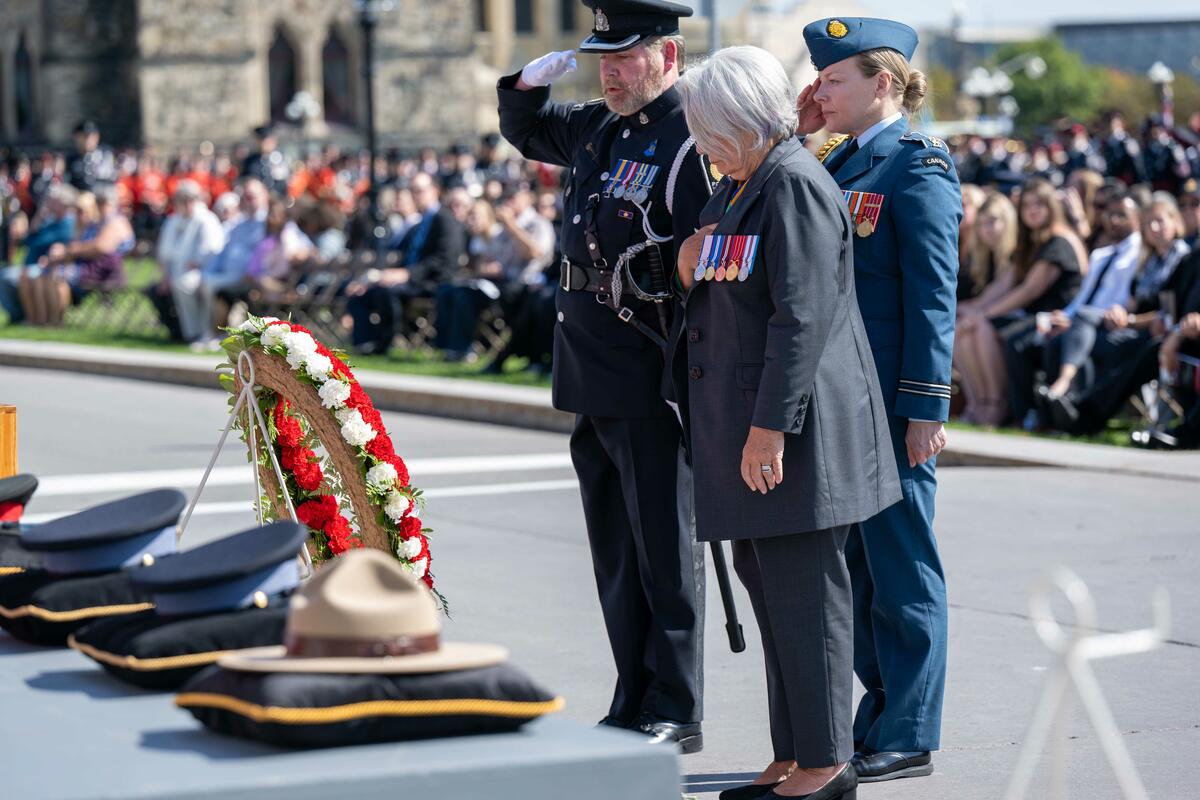 Governor General Mary Simon stands with her hand on her chest after having laid a wreath