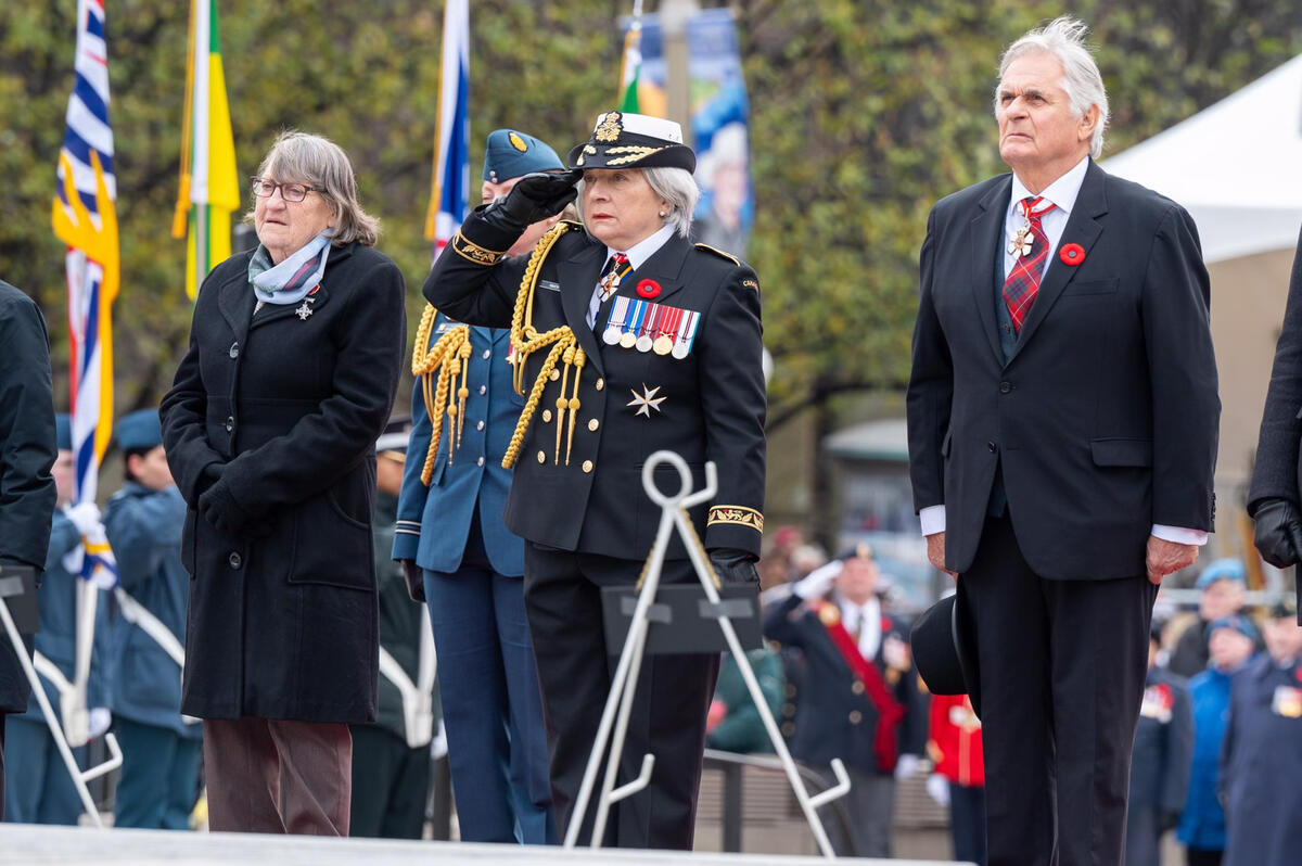 Governor General Mary Simon, accompanied by Mr. Whit Fraser, salutes