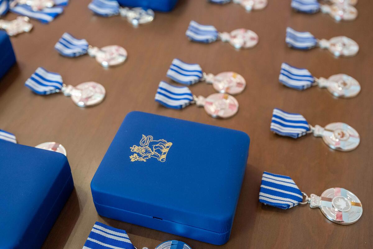 Picture of Meritorious Service Decorations on a table with a blue box