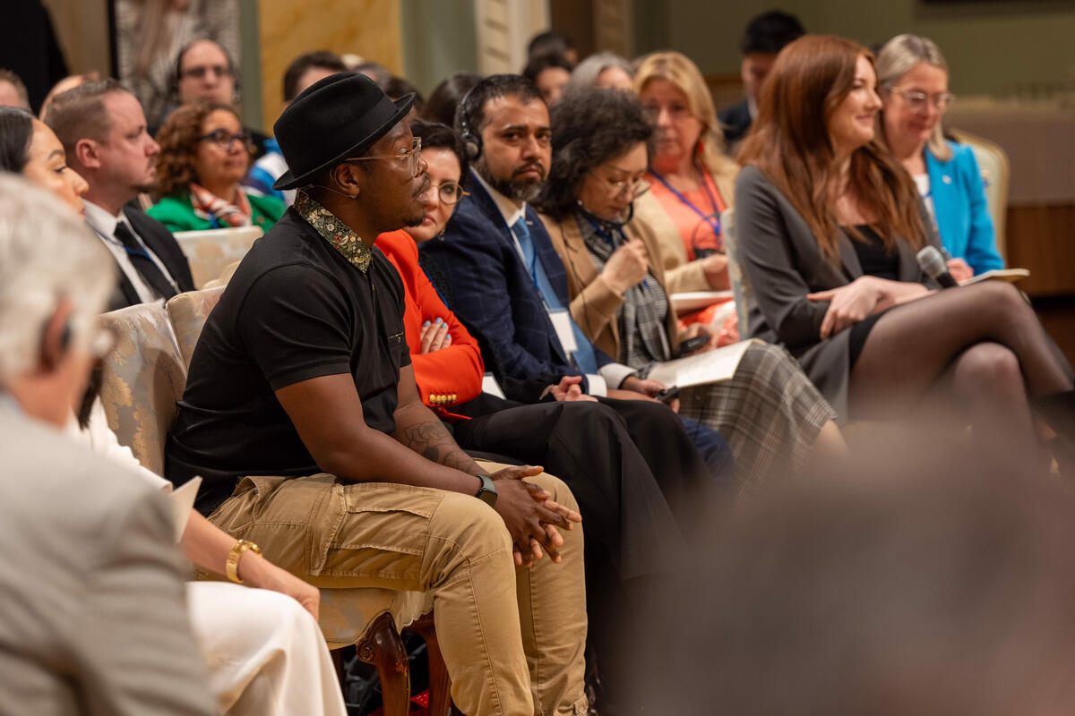 Kevin Raphaël speaks during the symposium