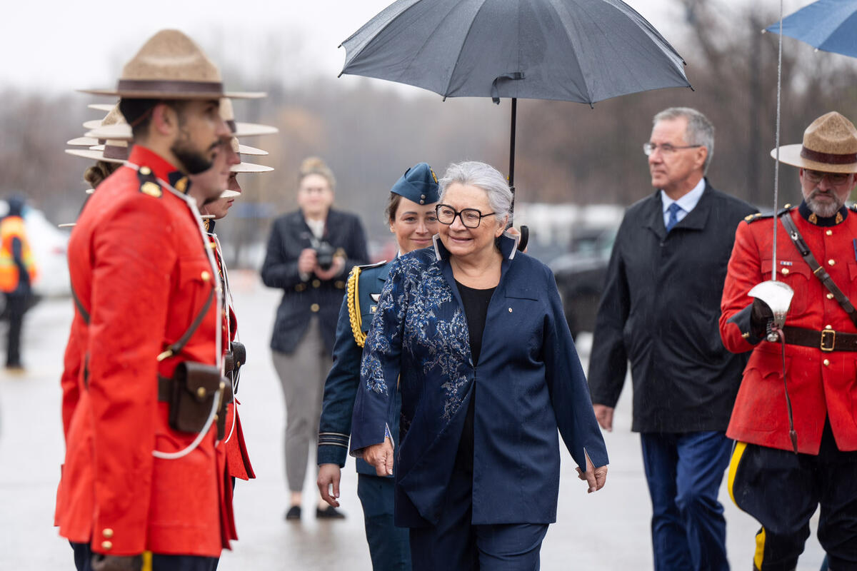 Governor General Mary Simon inspects a guard of honour made up of members from the Royal Canadian Mounted Police
