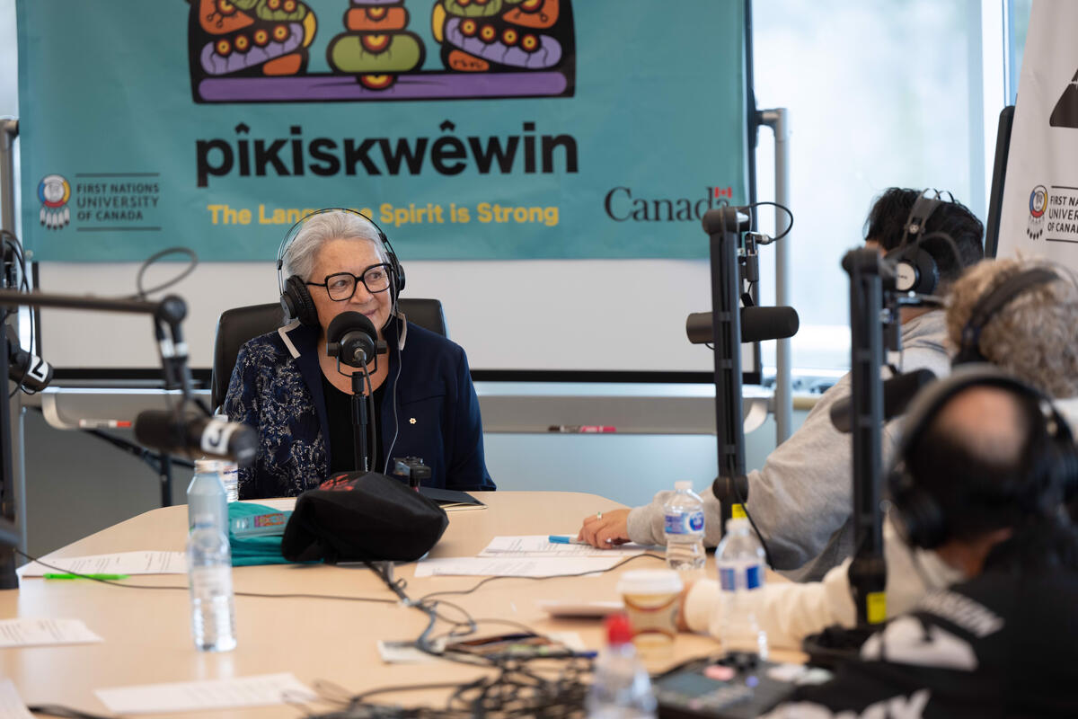 Governor General Mary Simon speaks in a microphone during a podcast