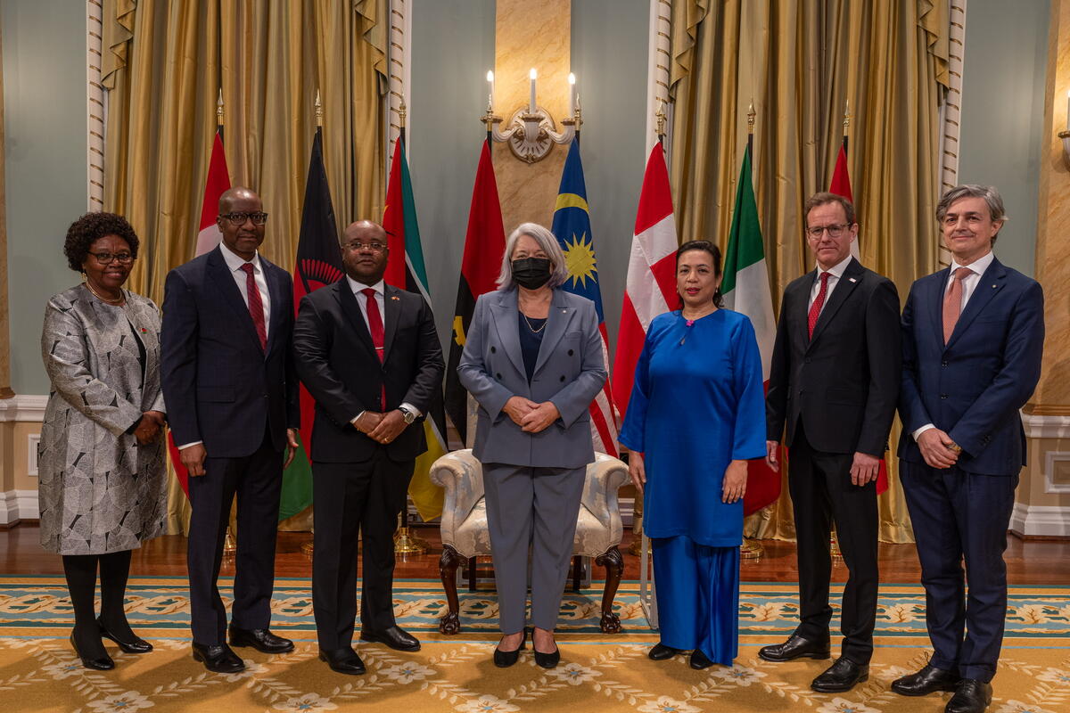 A group photo with Governor General Simon and six new heads of mission, with the flags of each country behind them.