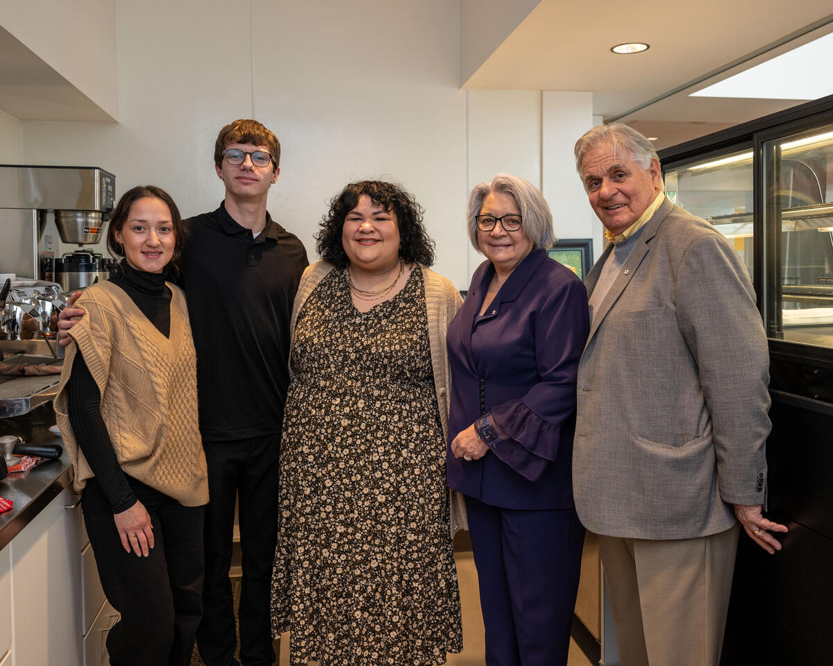 Governor General Mary Simon and Mr. Whit Fraser standing by coffee machines with 3 other people.