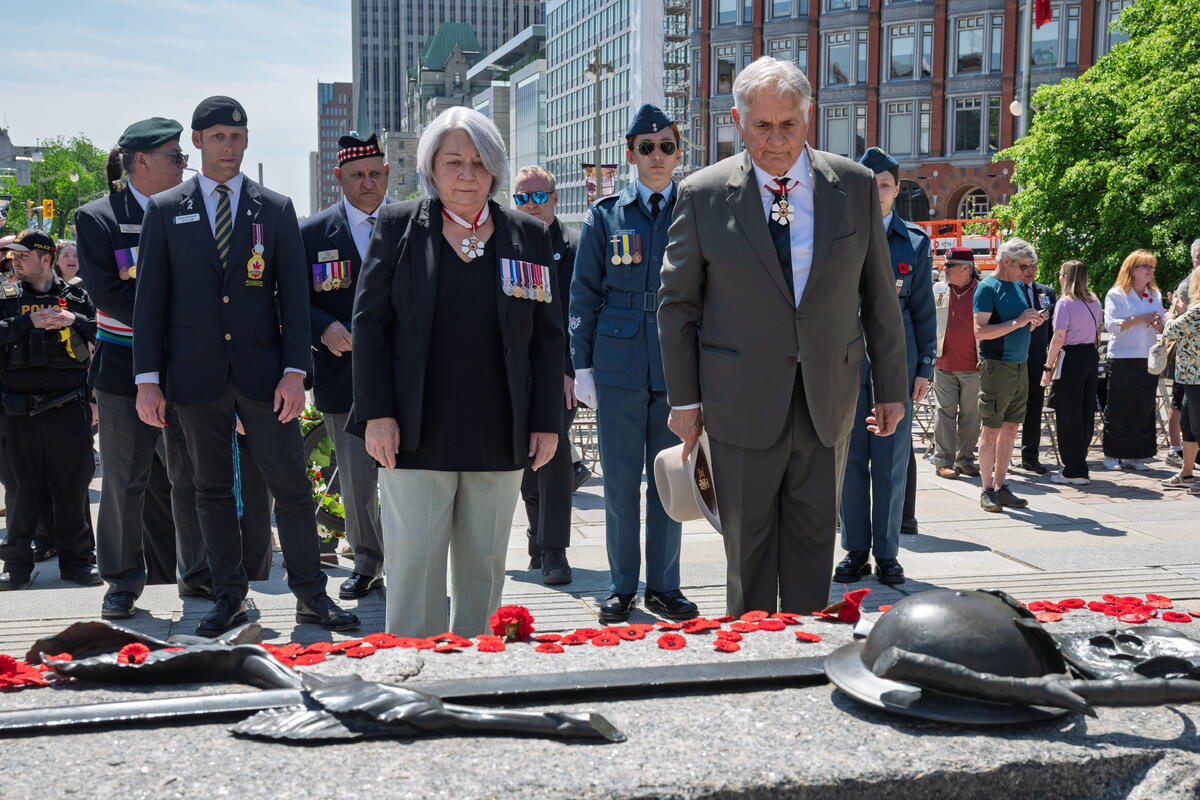 Their Excellencies standing before the Tomb of the Unknown Soldier. There are several poppies on the tomb.