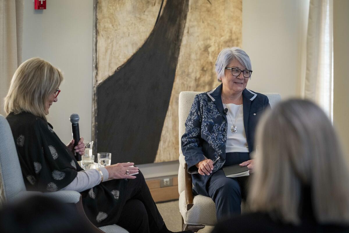 Governor General Mary Simon sitting with a small group of people having a discussion.