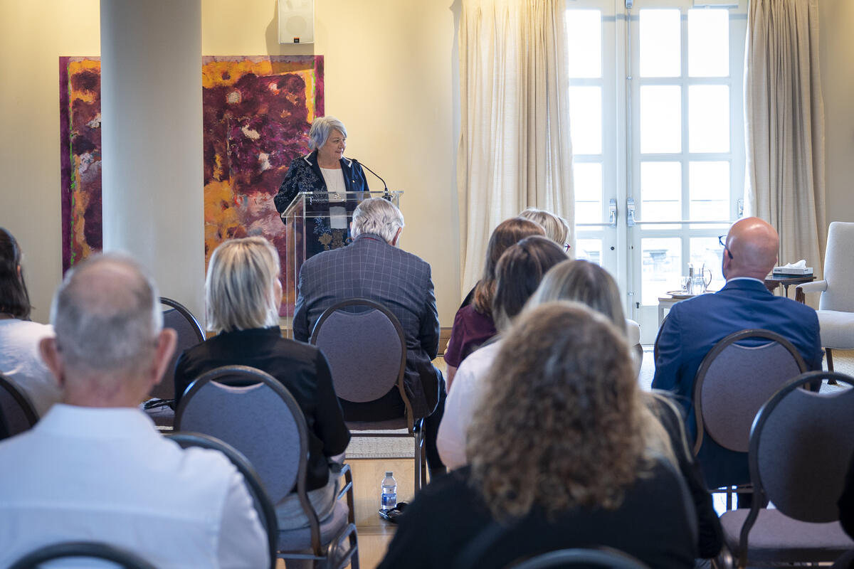 Governor General Mary Simon is standing at a podium addressing a room of people.