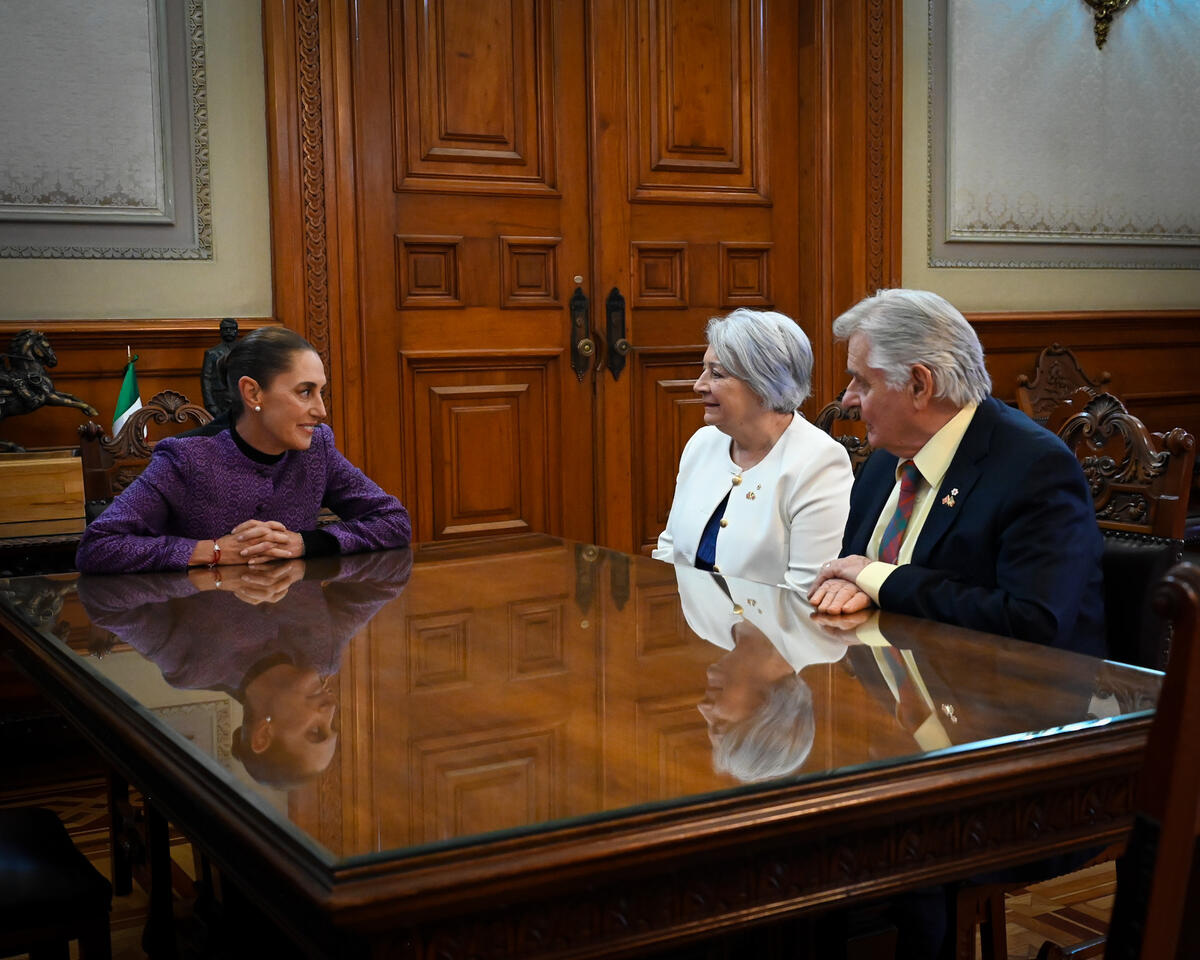 Left to right: Her Excellency Claudia Sheinbaum Pardo, President of the United Mexican States, Governor General Mary Simon and Mr. Whit Fraser seated at a large table.