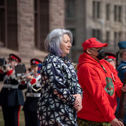 Governor General Mary is standing outside. Others stand to her left.