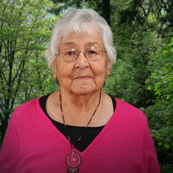 Member of the Order of Canada - Elder Ruth Christie. She is wearing a fuschsa coloured top and a beaded necklace.