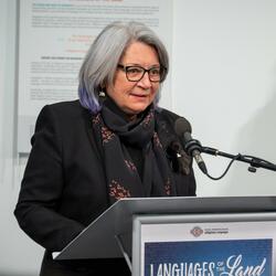 Governor General Mary Simon is standing at a podium delivering remarks.