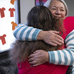 Two women embracing.