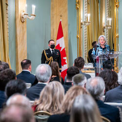 Governor General Simon is addressing a crowd in the Ballroom at Rideau Hall.