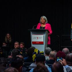 The Governor General is standing at a podium